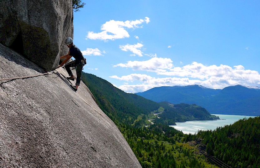 Climber working his way along Skywalker with the view of Howe Sound below