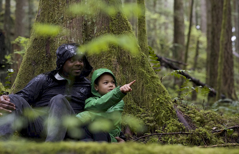 Father and son taking in the rainforest around Squamish