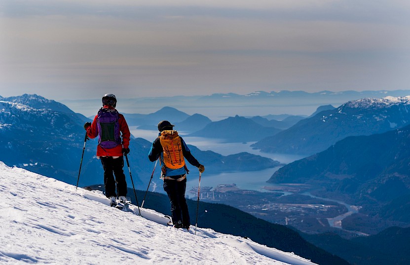 Couple ski touring with view over Squamish & Howe Sound