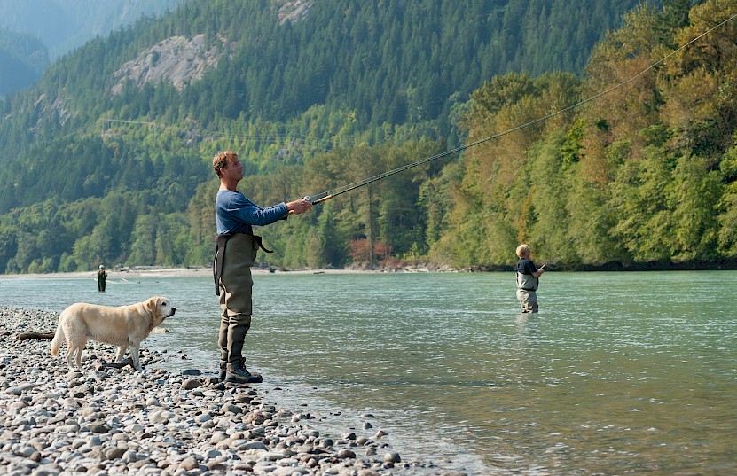 A fisherman and his dog on the Squamish River