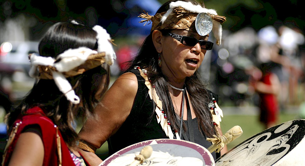 Two women participating in a drum circle