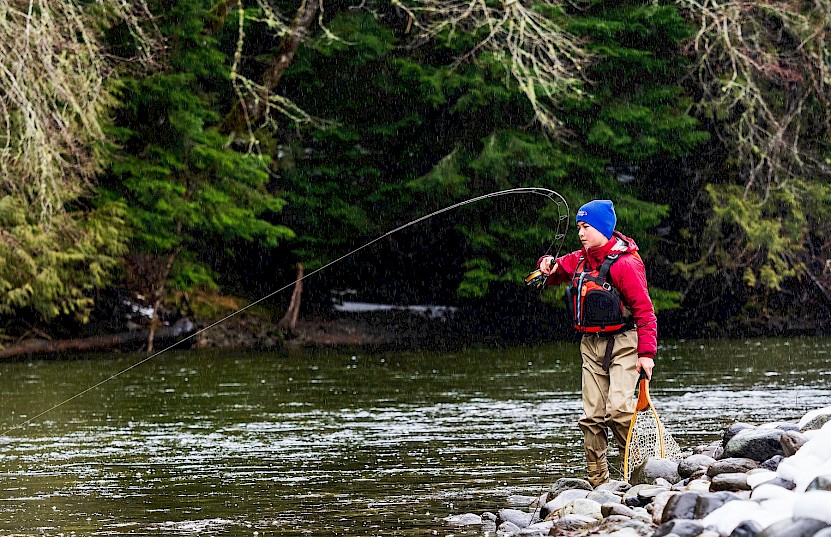 Boy fly fishing in the Cheakamus River