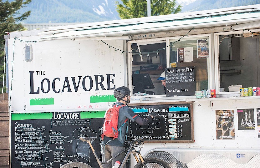 Person with a bike picking up their order from the Locavore food truck in Squamish