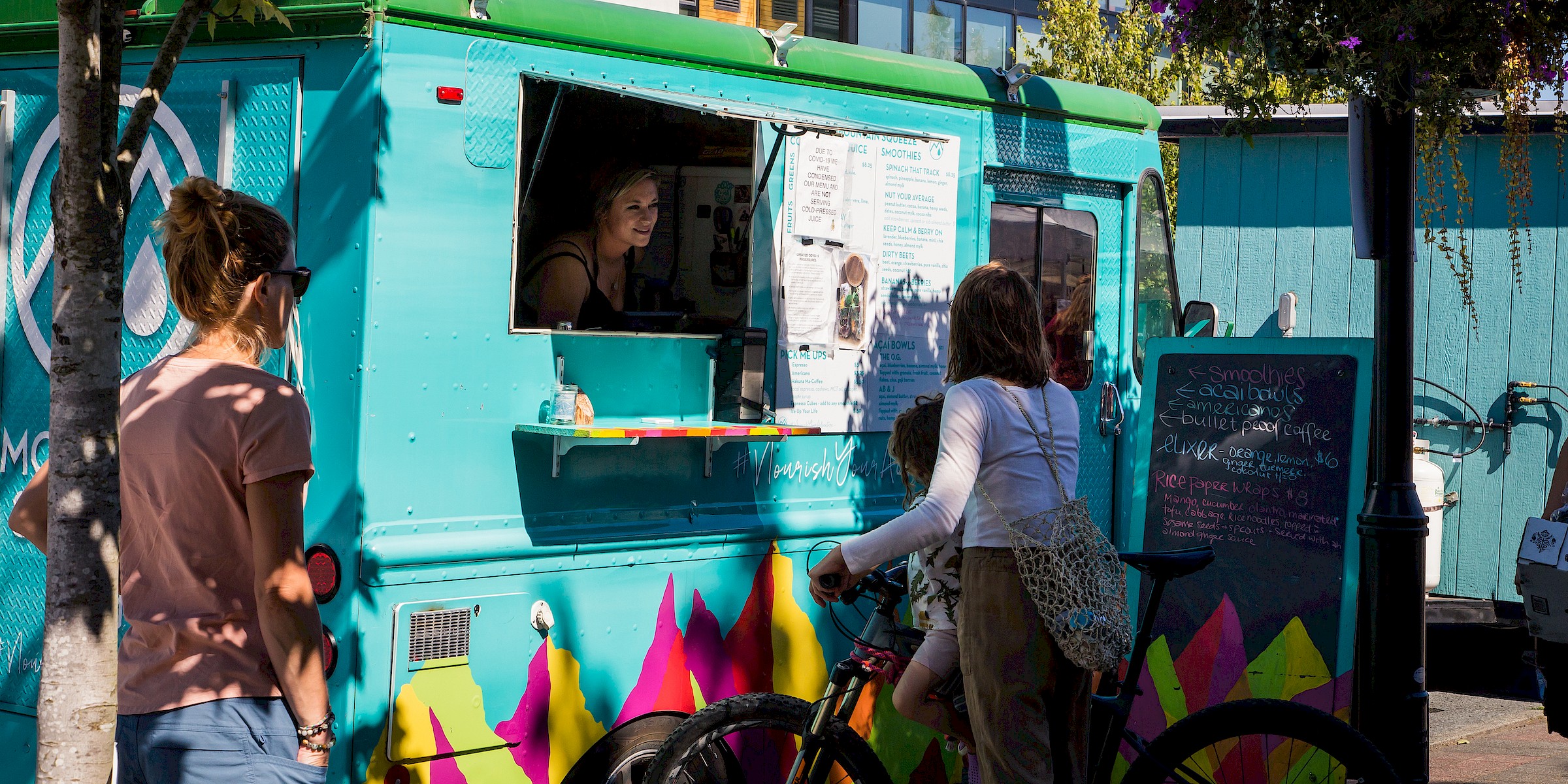 Customer picking up an order from a food truck in Squamish