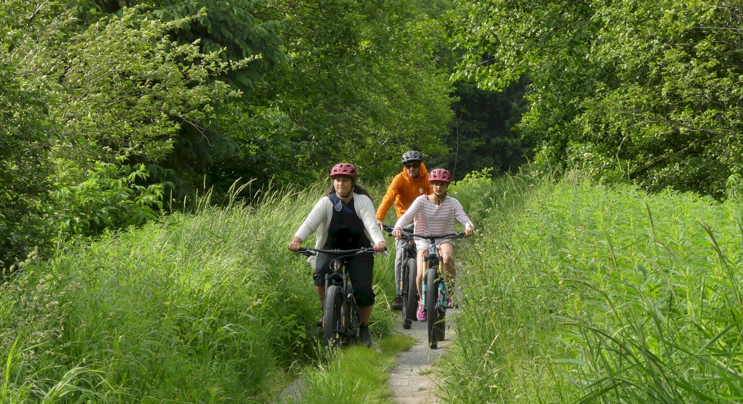 Family biking on path