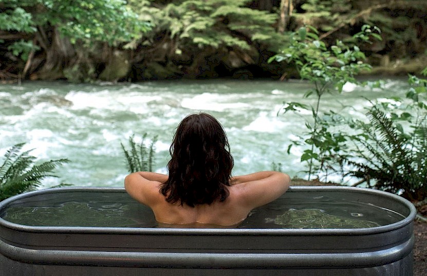 Woman enjoying a soak while watching the river