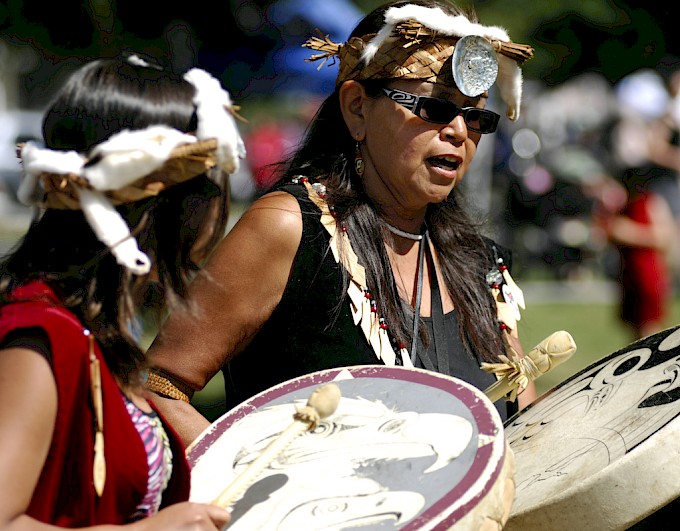 Two women participating in a drum circle