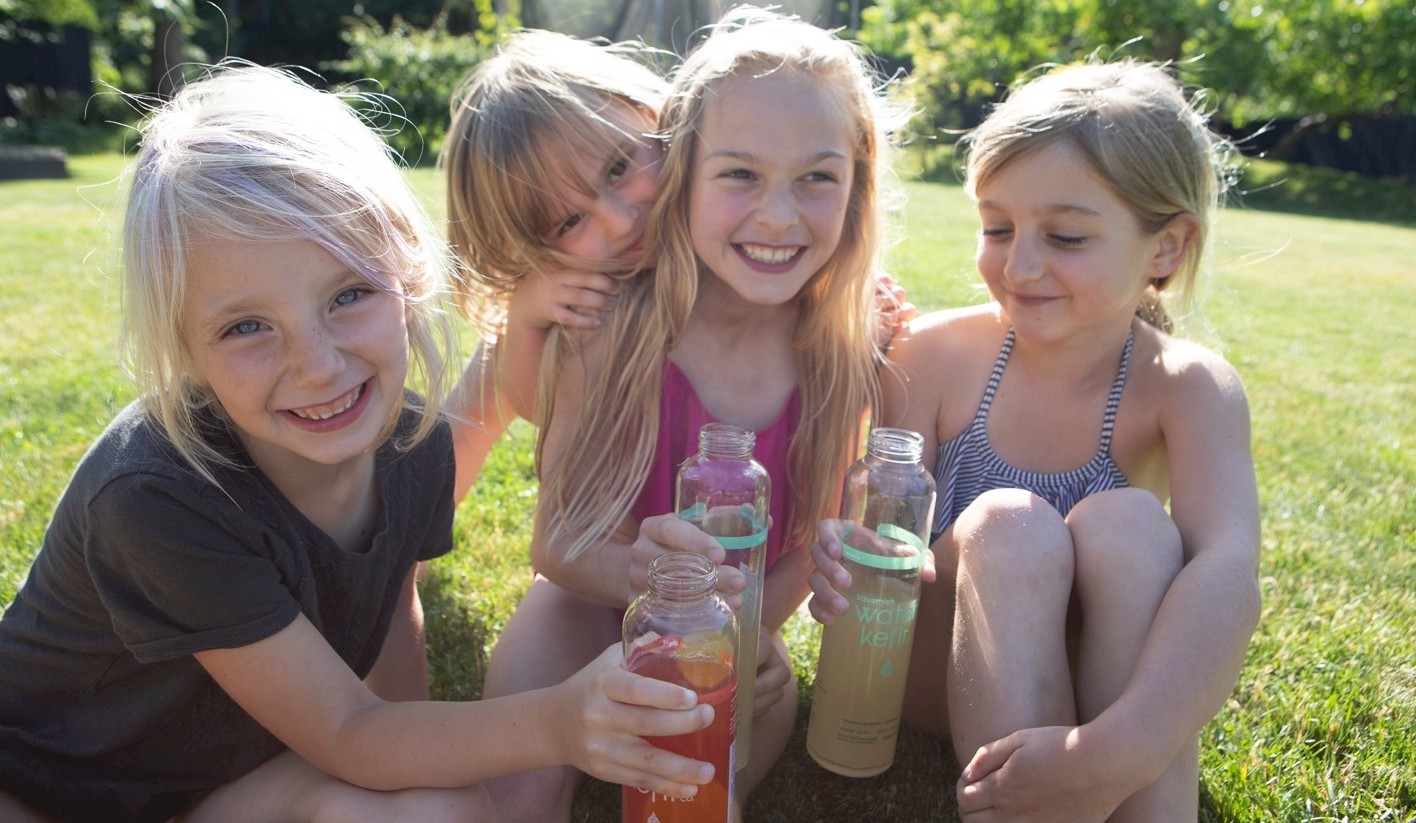 Group of girls sitting in grass and smiling