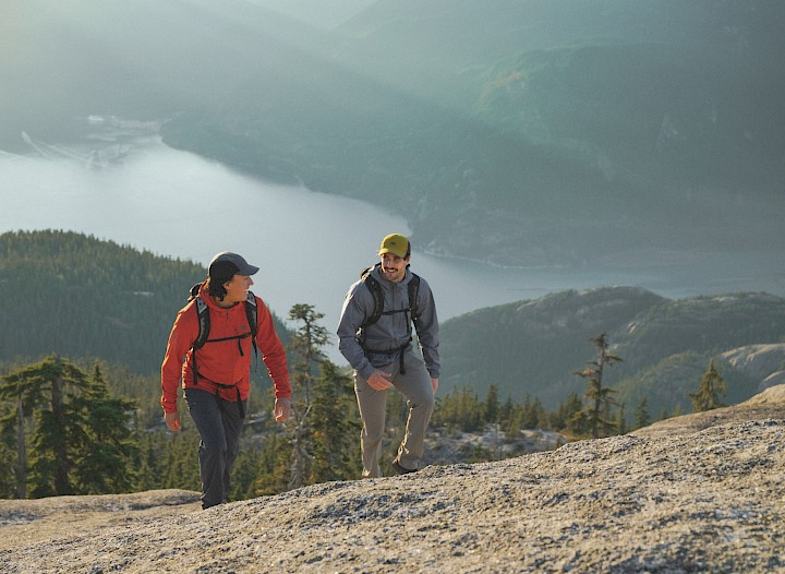 Two friends hiking in the fall sun