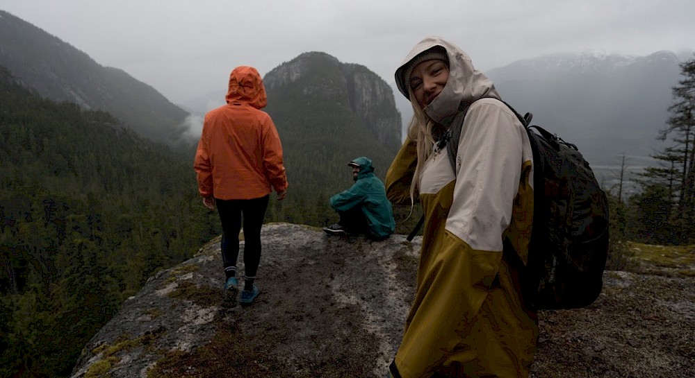 Woman on bike on a bike trail followed by a dog