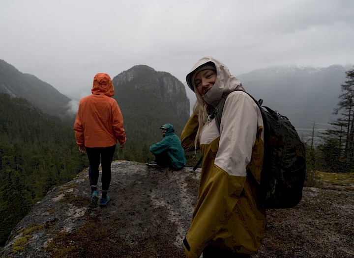 Woman on bike on a bike trail followed by a dog