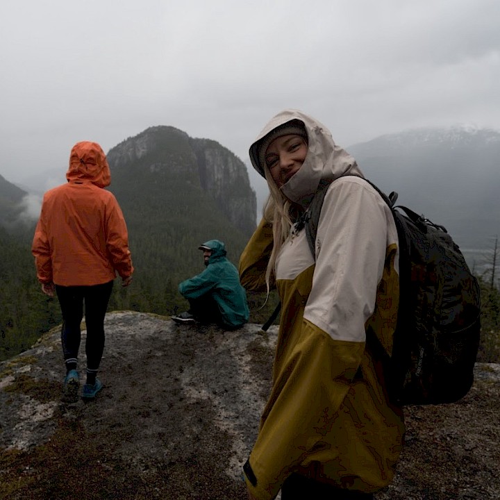 Woman on bike on a bike trail followed by a dog