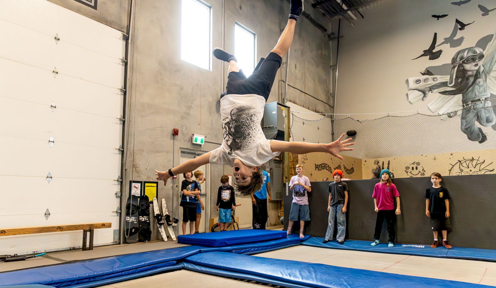 Child jumping upside down on a trampoline at Airhouse