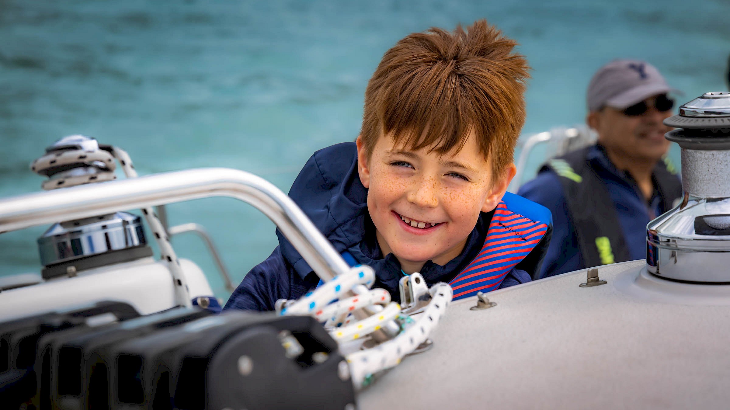 Child smiling on a sail boat